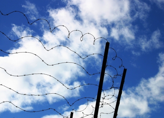 Picture showing barbed wire against the blue sky